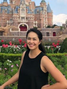 Woman standing in front of Disney castle